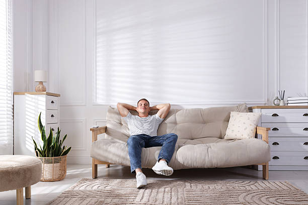 istock Young man relaxing on sofa at home 2246234668