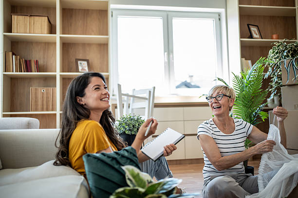 istock Mother daughter laughing while unpacking in new home 2246234888
