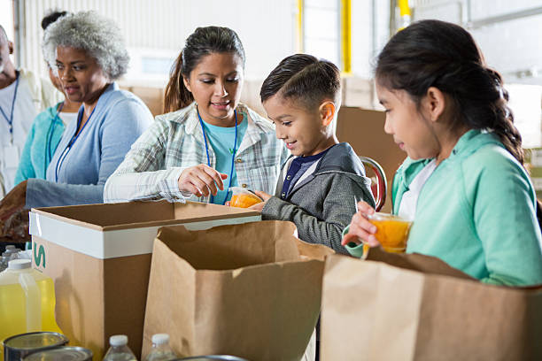istock Volunteers collaborate to prepare food packages for community distribution. 2246234900