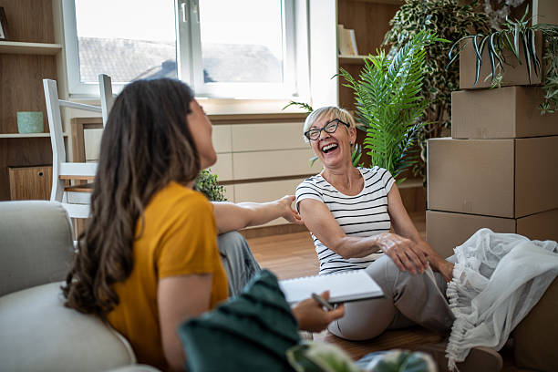istock Mother and daughter laughing during home move 2246234914