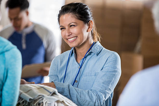istock Diverse group of people smiling while working together to help the community. 2246234924