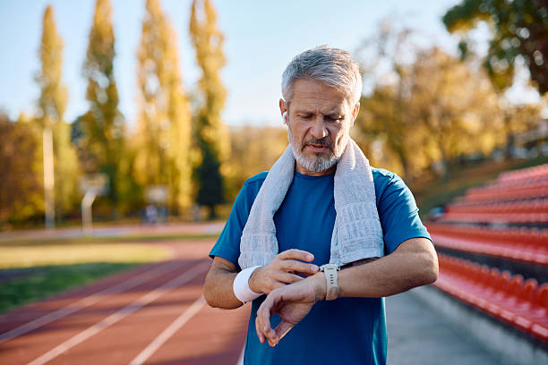 istock Mature runner using fitness tracker at the stadium. 2246236114