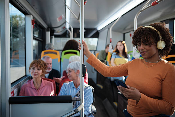 istock Young woman commuting on public transport browsing phone 2246237286