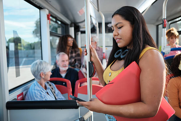 istock Young woman commuting by bus looking at smartphone 2246237303