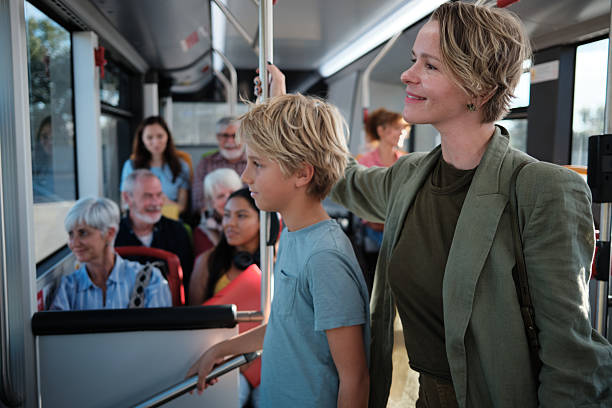 istock Mother and son riding public transport bus 2246237354