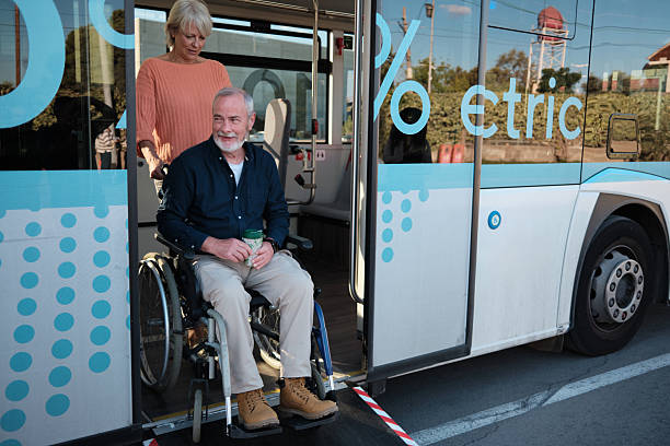 istock Senior couple using wheelchair ramp on electric bus 2246237357