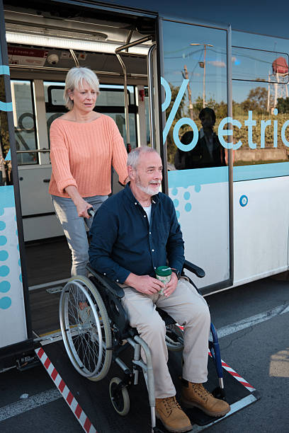 istock Senior couple using wheelchair ramp on accessible bus 2246237360