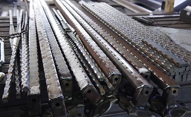 istock Welding and industrial design. Decorative forged elements, including ornate scrolls and twisted rods, are assembled on a workbench. Tools and equipment, workspace. 2246238237