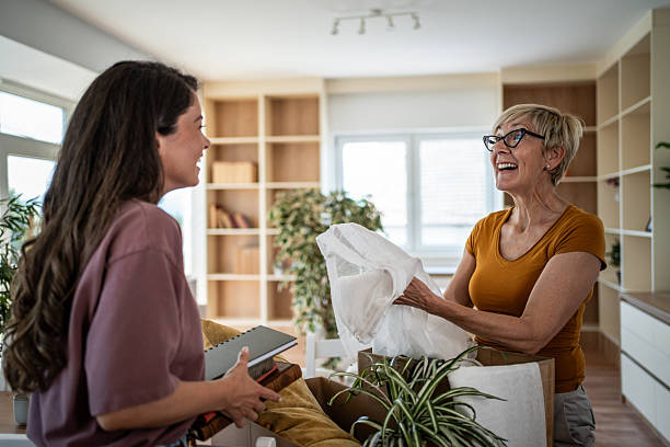 istock Mother daughter moving packing unpacking boxes new home 2246239233