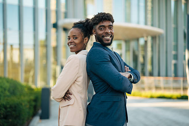 istock Successful business people standing back to back smiling outdoors 2246239817