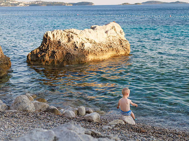 Boy playing on the seashore on the beach.