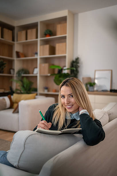 istock Woman journaling in her living room, writing notes 2246242601