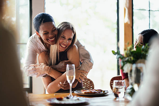 istock Happy Friends Share Warm Hug During Female Lunch Celebration At Elegant Dinner Table 2246245338