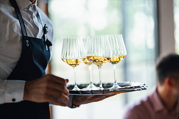 istock Waiter Serving White Wine Glasses On Tray At Elegant Dinner Event 2246245361