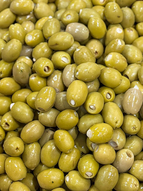 Image of full frame dishes of mixed stuffed olives with garlic and peppers, green and black varieties, Italian salad ingredients