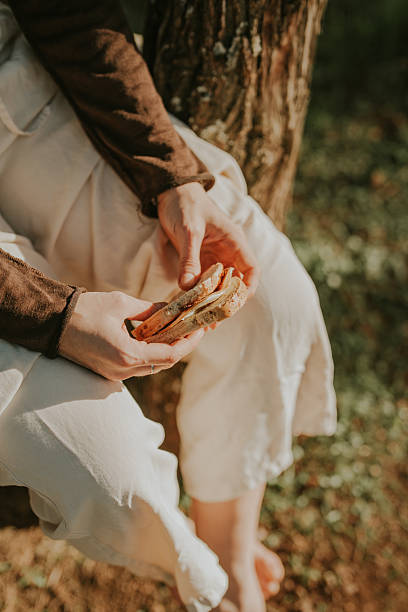 Portrait of a red-haired woman in her kitchen. She afforded herself a slice of raspberry pie. She eats the cake with her hands. She enjoys this moment.