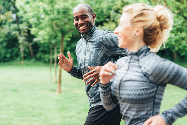 istock Cardio training outdoors. Happy athletic couple having fun while running together in nature. 2246247171