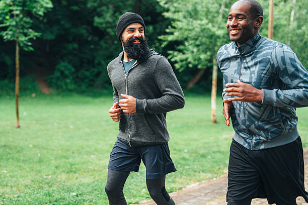 istock Cardio training outdoors. Happy athletes having fun while running together in nature. 2246247184