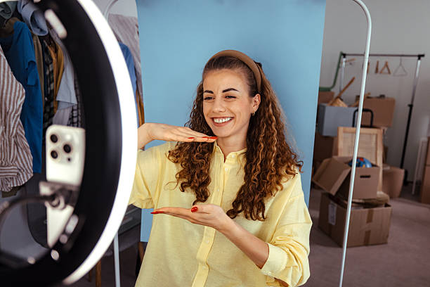 istock Woman vlogging at home using smartphone and ring light 2246248374