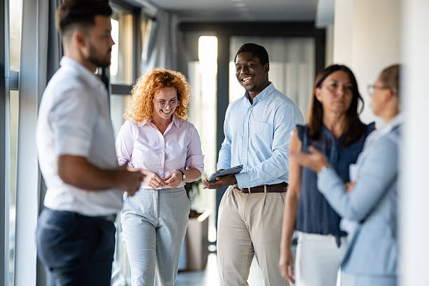istock Successful diverse business team communicating in office hallway 2246248818