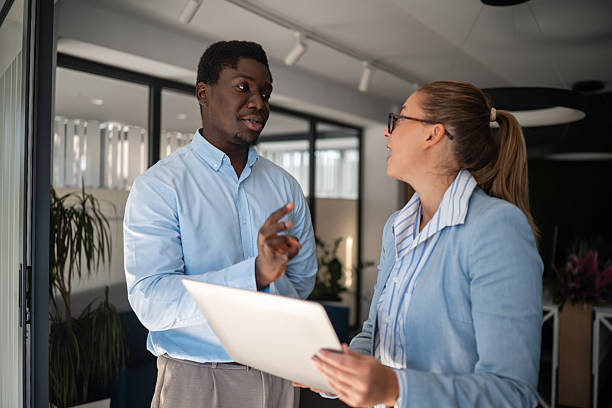 istock Business colleagues discussing project details in office setting 2246248872