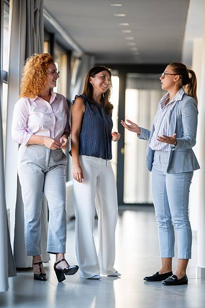 istock Confident businesswomen engaging in workplace conversation 2246249196