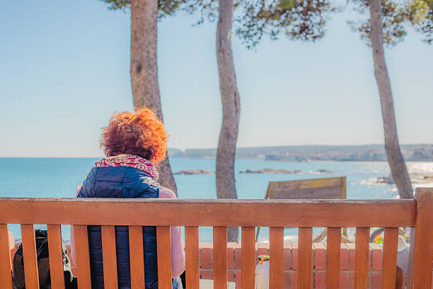 istock An elderly woman reading a book 2246249450