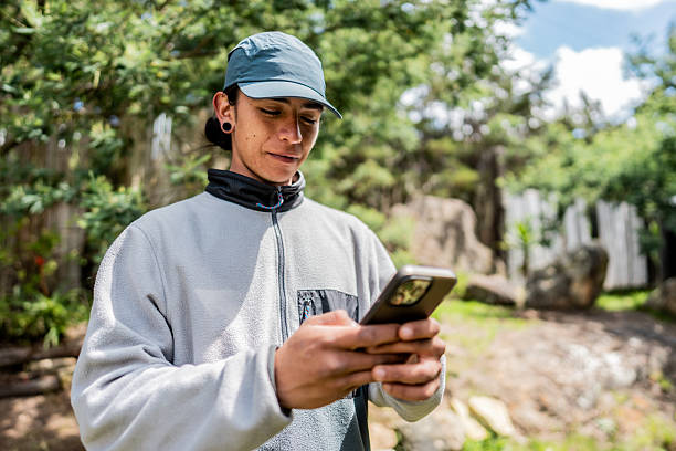istock Young man using mobile phone outdoors 2246250625