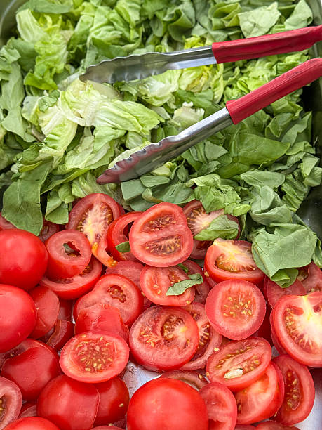 Image of salad bar sliced tomato slices lettuce leaves healthy eating, fresh vegetable selection, nutritious meal, crisp leafy greens, vibrant tomatoes