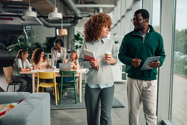 istock Diverse coworkers collaborating and discussing business strategy in office 2246251720