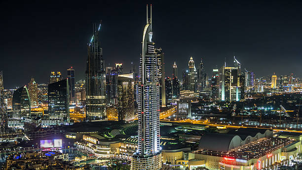 istock Dubai downtown skyline timelapse at night. Rooftop view of Sheikh Zayed road with numerous illuminated towers. 2246252631