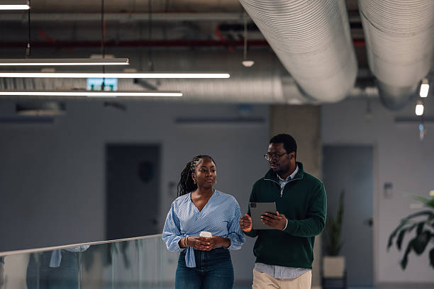 istock Business colleagues walking and discussing during office meeting 2246253313