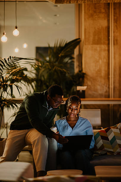 istock Coworkers collaborating on laptop discussing project in office 2246253375