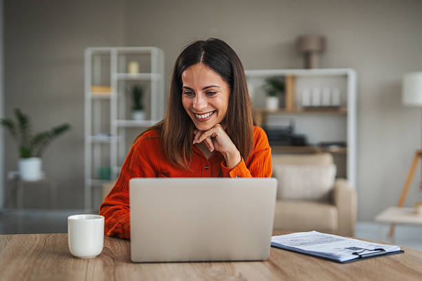 istock Woman working from home using laptop smiling 2246253501