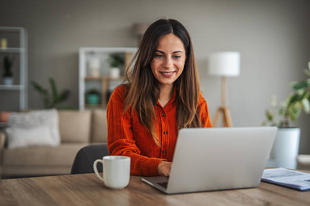 istock Woman working from home using laptop smiling 2246253537