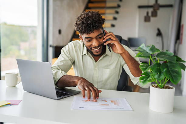 istock Young man on phone call working from home office 2246253739