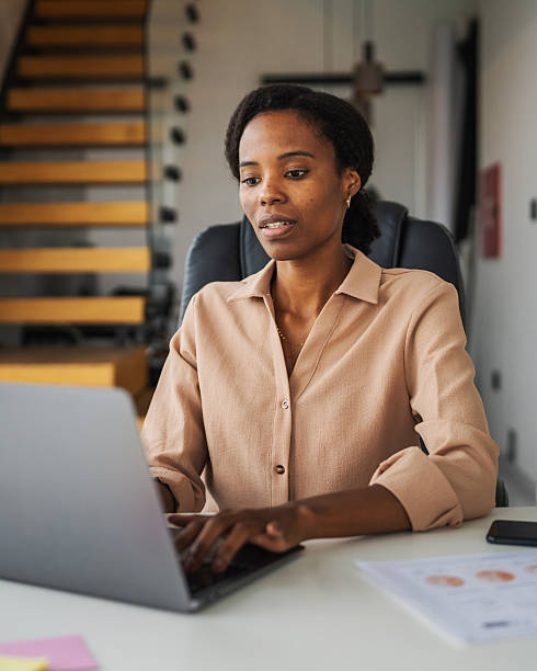 istock Black woman working on laptop at home office 2246253745