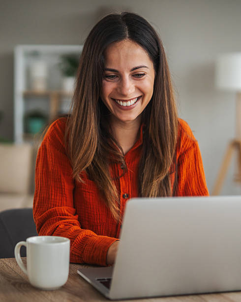 istock Woman working from home using laptop smiling 2246253786
