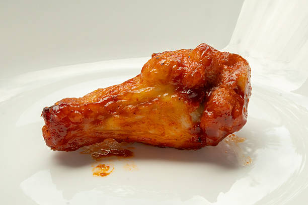 Grilled spicy chicken wing on white plate