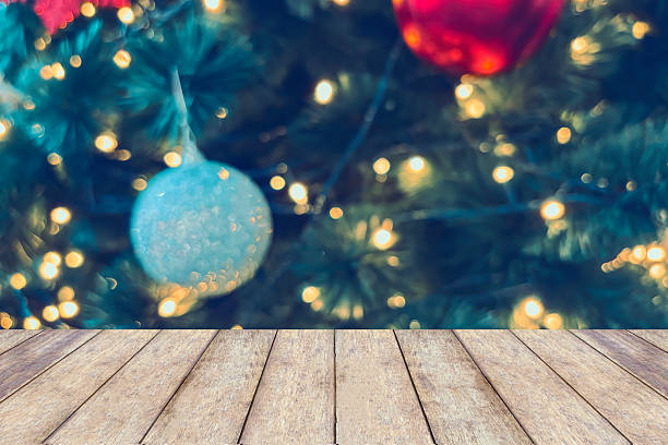 istock Empty wood table top with blur Christmas tree with bokeh light background 2246254435