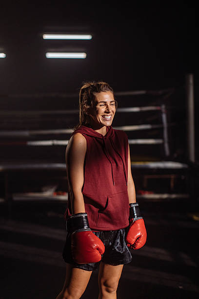 istock Confident Female Boxer In Red Gloves Smiles In Gym During Training Session 2246255165
