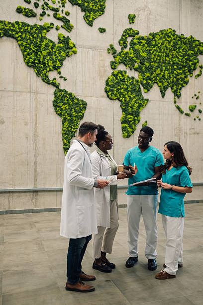 istock Medical professionals discussing global health with moss map 2246256406
