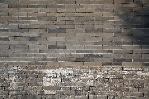 istock Ancient gray brick wall with some weathered patches showing texture 2246256421