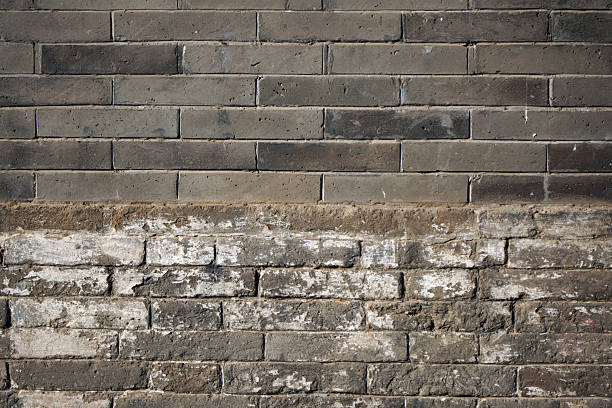 An old brick wall showing signs of wear and tear with distinct historical texture and structure.