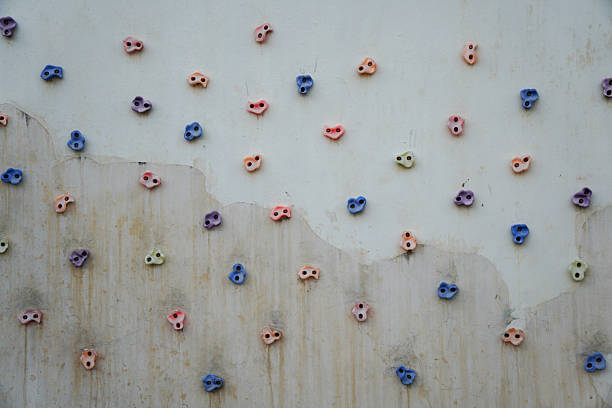 Colorful climbing holds on a wall for rock climbing, showcasing various grips for climbing activity.