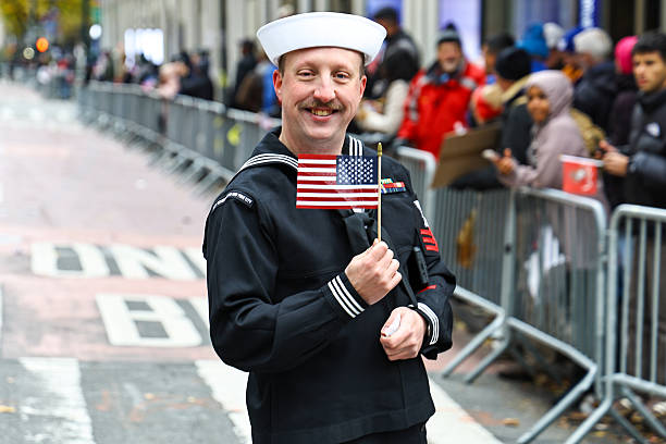 A member of the United States Navy waves a flag during the Veterans Day Parade in New York on Nov. 11, 2025.