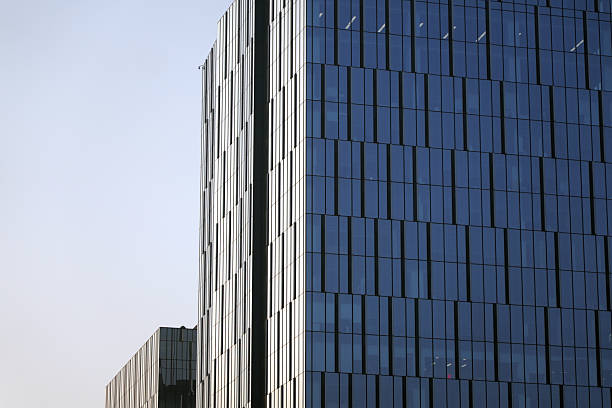 istock Modern glass skyscraper with reflective surfaces under clear sky 2246256734