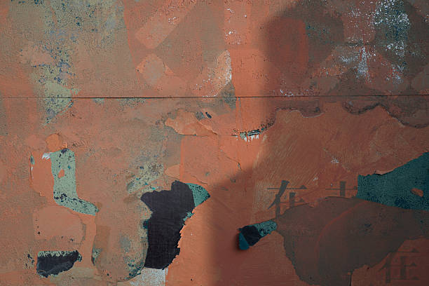 istock Abstract wall with peeling paint showing various colors and textures 2246256862