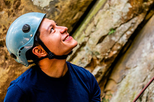 Mid adult climber man looking up during a climb