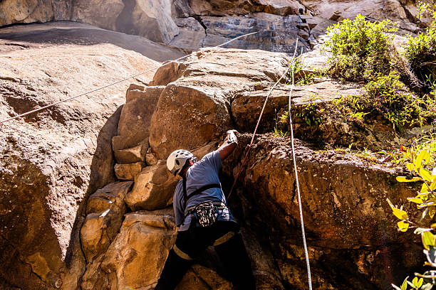 Mid adult climber man climbing mountain